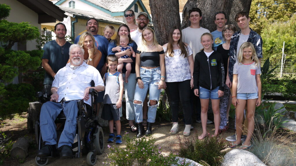 Gale Williams is sitting in his wheelchair, surrounded by his beautiful family in the garden of his home in Santa Monica